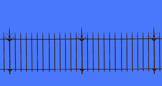 A wrought iron fence isolated on the blue background