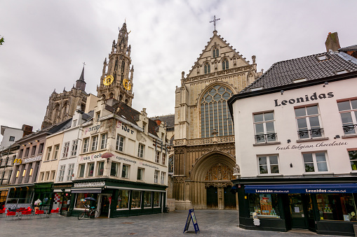 Antwerp, Belgium - July 2019: Cathedral of Our Lady tower and streets of Antwerp