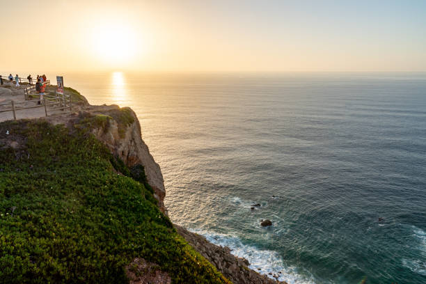 westernmost point of continental europe, cabo da roca at dusk, sintra, portugal - sintra sunset cross outdoors ストックフォトと画像