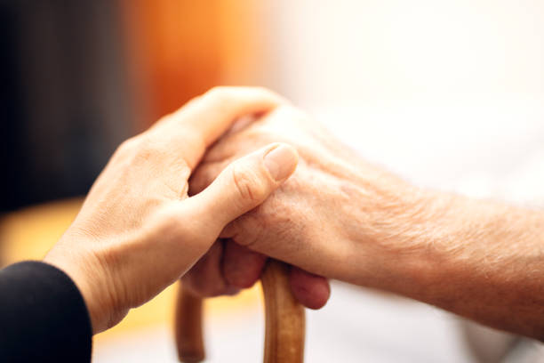 Close up hands of helping hands elderly home care.