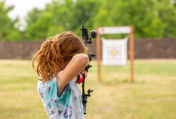 istock Rear View Of Girl Practicing Archery at Outdoor Range 1938041209