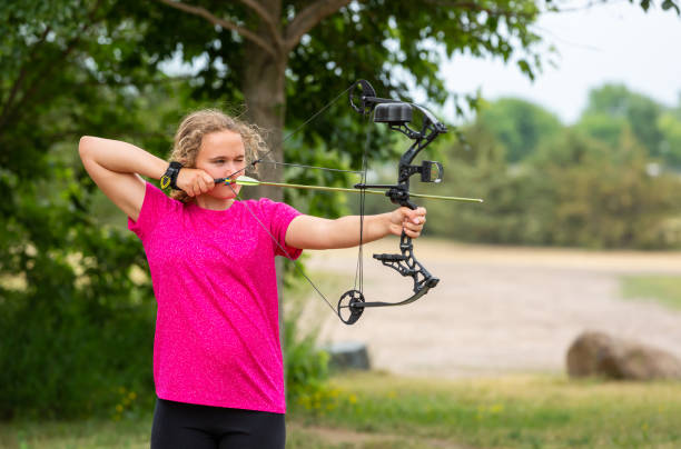 Girl Practicing Archery Outdoors