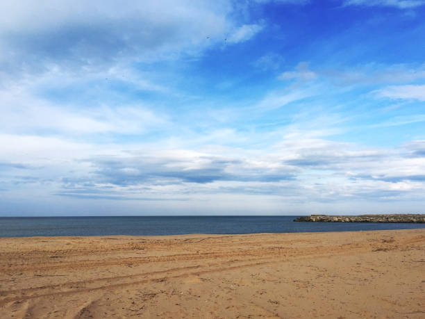 istock Seascape with sand and sky background 1938077002