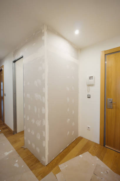 istock photograph of construction work in a house, unfinished plasterboard wall 1938077539