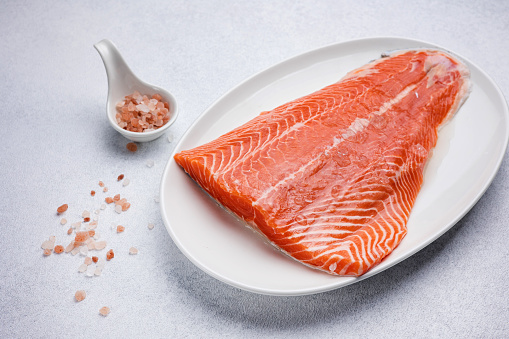 fresh, delicious salmon fillet on a white plate