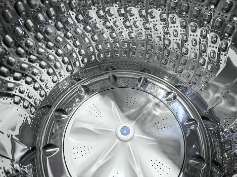 Looking inside of a stainless steel washer drum of an automatic washing machine