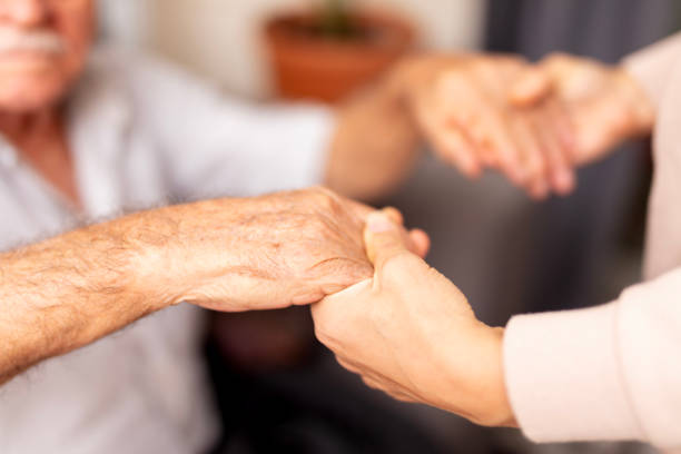 istock Close up hands of helping hands elderly home care. 1938083930