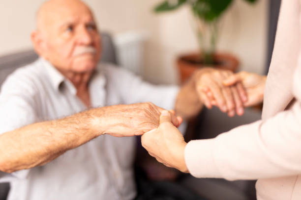 istock Close up hands of helping hands elderly home care. 1938083931