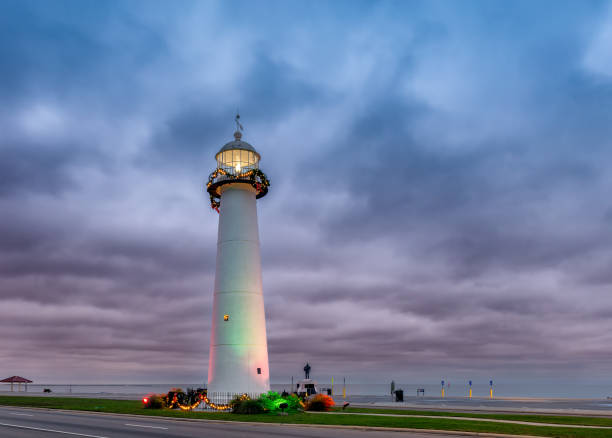 Biloxi Lighthouse at sunrise with dramatic stormy sky in Biloxi, Mississippi, USA.