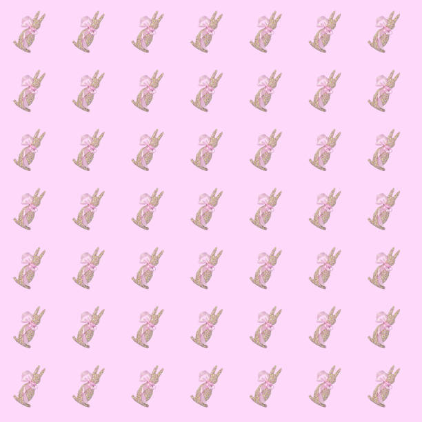 Pattern of textile soft toy Easter Bunny on pink background. Minimalist Easter greeting card. Easter celebration concept, flat lay.