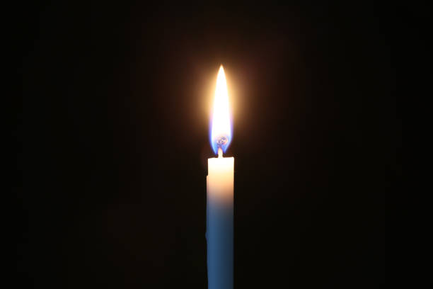 istock Candle and its light isolated on a black background. 1938126667