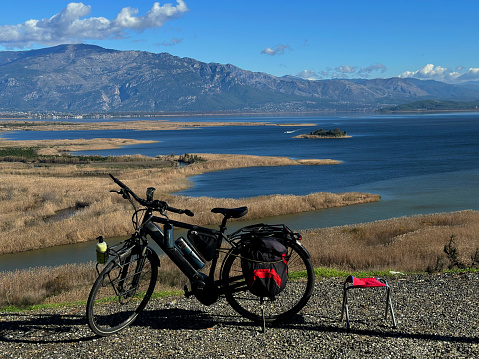 a bike camper takes a break on a high point view of Köyceğiz lake,