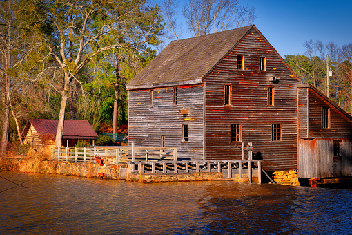 A nice landscape of the historic gristmill at Yates Mill Park at sunset in North Carolina.