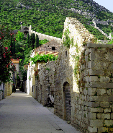 Street in Ston with old stone houses and city wall