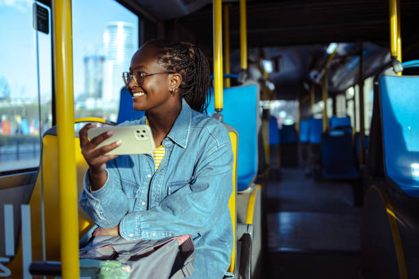 istock Young woman using smart phone in public transport 1938337700