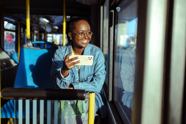 istock Young woman using smart phone in public transport 1938340314