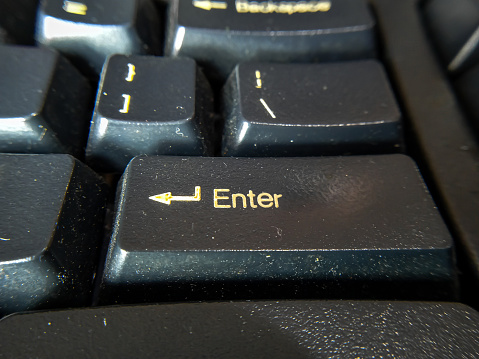 Close up photo of the enter key on a computer keyboard. selective focus