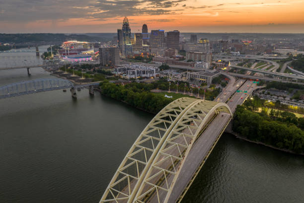 istock Highway traffic in Cincinnati, Ohio on Daniel Carter Beard Bridge with brightly illuminated high skyscraper buildings in downtown district. American city with business financial district at night 1938382856