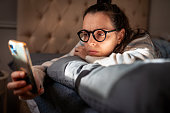 Worried woman at home checking smart phone