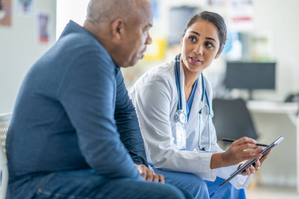 istock Doctor Talking with a Senior Patient 1938542770