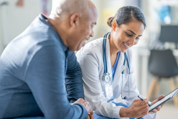istock Doctor Talking with a Senior Patient 1938542776