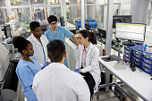 Group of scientists talking in a staff meeting at the laboratory