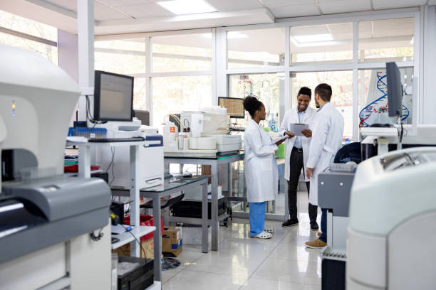 istock Happy group of doctors working at the laboratory 1938554571