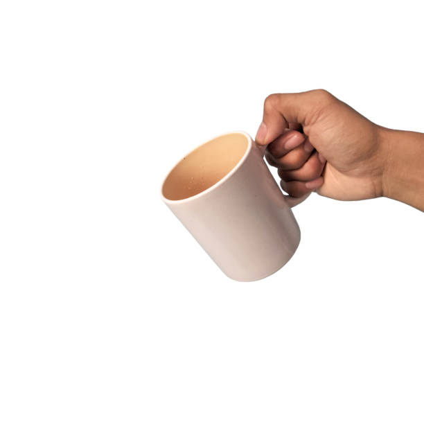 istock Man's hand holding a cup isolated on white background 1938559389