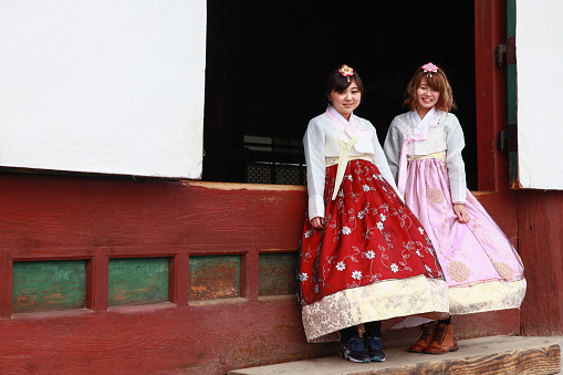 Girls in traditional bulgarian ethnic costumes with folklore embroidery holding hands. The spirit of home Bulgaria - culture, history and traditions.