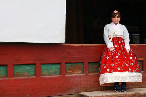 Seoul, South Korea - November 27, 2016. The Gyeongbokgung Palace in Seoul. Visitors dressed in traditional Korean Hanbok costumes.