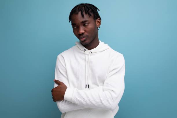 istock calm model dark-skinned young brunette man in a white sweater 1938575757