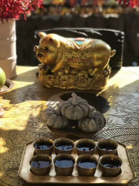Photo of chinese tea ceremony with gold ingots and a piggy bank