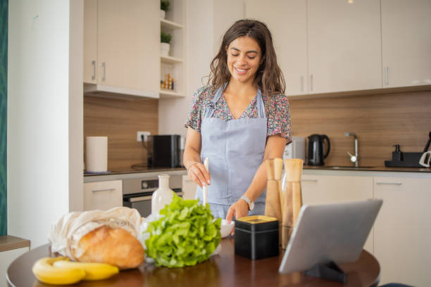 istock Young woman is preparing a meal 1938592415