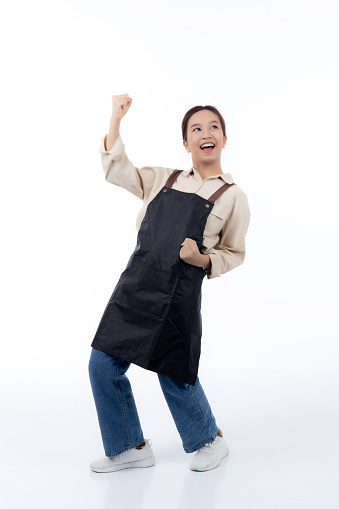 Portrait young asian barista woman wearing apron standing and smile isolated white background, waitress or entrepreneur cheerful, small business or startup, waiter of cafe or coffee shop.