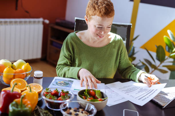 istock Female nutritionist makes a diet plan for a client. Healthy life 1938643882