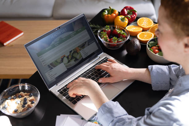 istock Female nutritionist makes a diet plan for a client and using laptop 1938652321