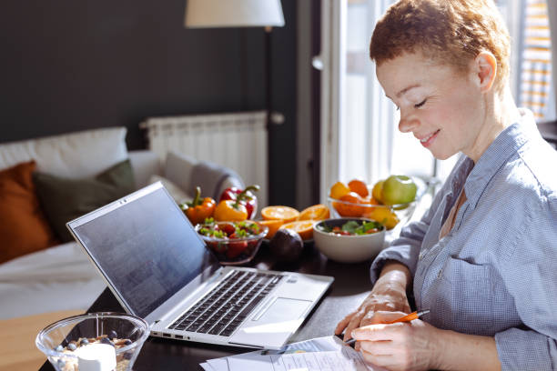 istock Female nutritionist makes a diet plan for a client and using laptop 1938652868