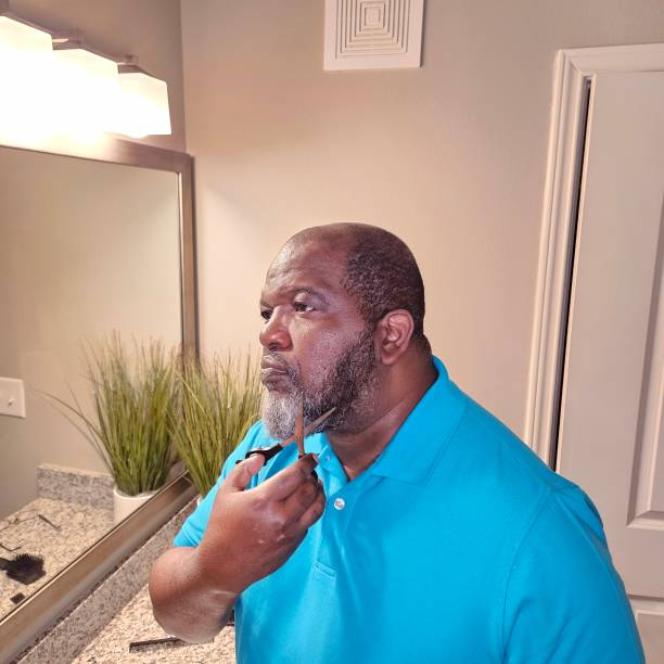 istock Personal Care Black Male Trimming Beard With Scissors 1938661529
