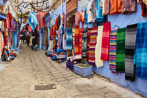 Street market with handmade colorful fabrics in Chefchaouen, Morocco, Africa.