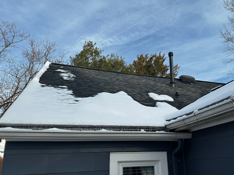 Snow melting on a roof where the interior heat is leaking through poor insulation
