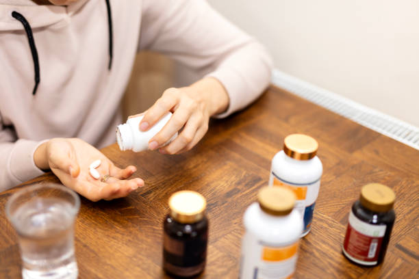 istock woman is taking pill with laptop 1938664596