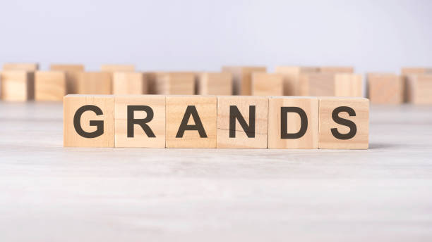 istock wooden cubes with letters GRANDS on a gray table 1938694369