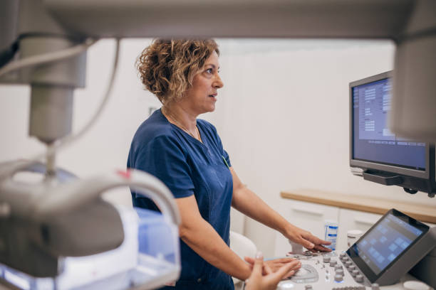 istock Female doctor working on ultrasound scanning machine 1938699599