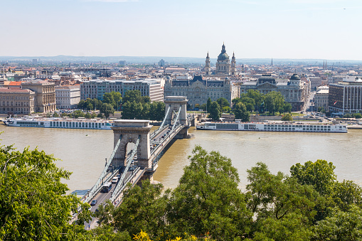 Chain Bridge crossing over the Danube river towards St Stephen cathedral.\nBudapest, Hungary