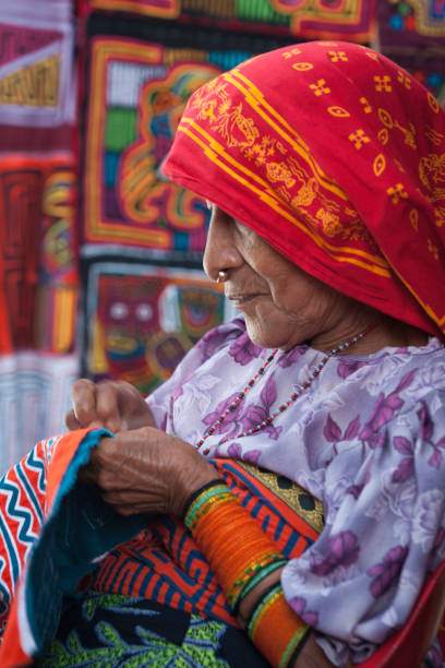 Kuna Yala, Panama - August 4, 2008: A Kuna Indian woman embroiders a mola, Playon Chico village, Kuna Yala, San Blas Islands, Caribbean coast of northern Panama, Central America