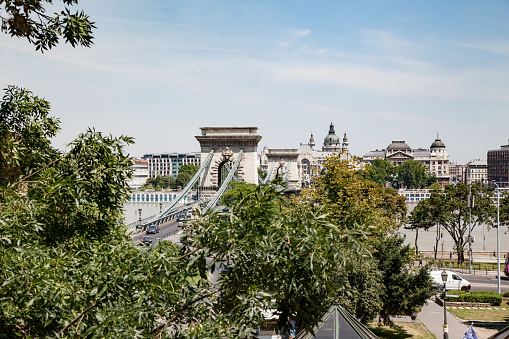 Chain Bridge crossing over the Danube river towards St Stephen basilica.\nBudapest, Hungary