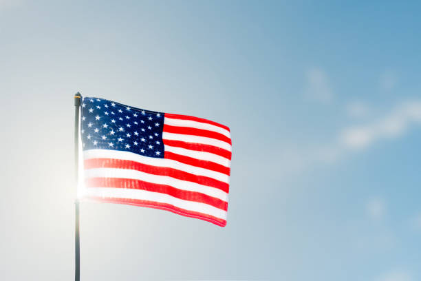 istock Pride and Patriotism: American Flag Against the Sunlit Sky 1938747548