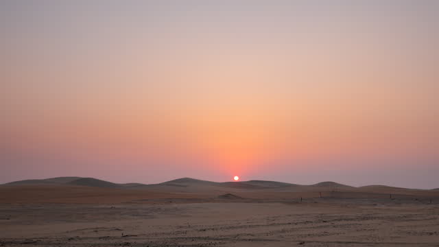 Beautiful dramatic clouds sunset sunrise time lapse over the desert sand dune