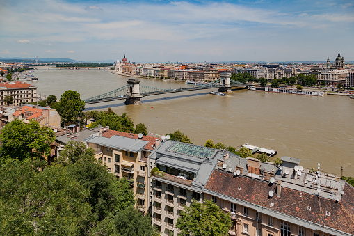 Chain Bridge crossing over the Danube river towards St Stephen basilica.\nBudapest, Hungary