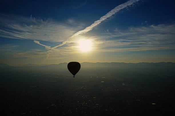 Hot Air Balloon rising with the sun over the Valley of Mexico while touring Teotihuacan